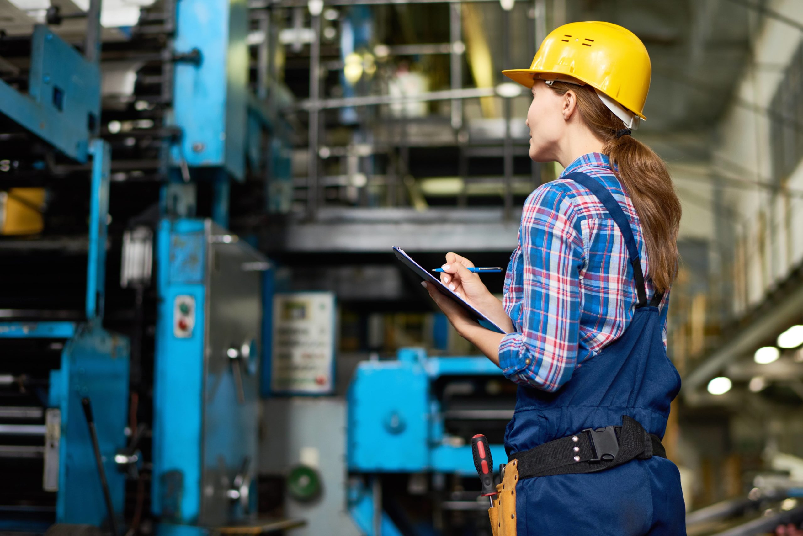 young woman doing inventory at a modern plant