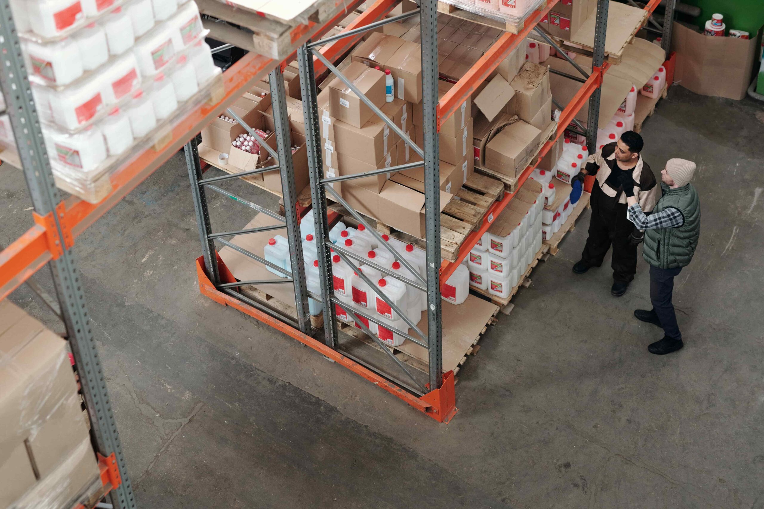 Two men working on satefy stock in warehouse